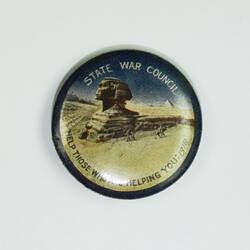 Badge with scene of Sphinx in desert.