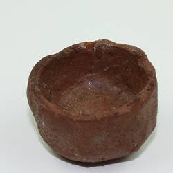 Toy bowl made from clay, viewed from side.