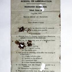 Deteriorated front of exam paper showing questions.