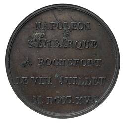 Round medal with raised text.