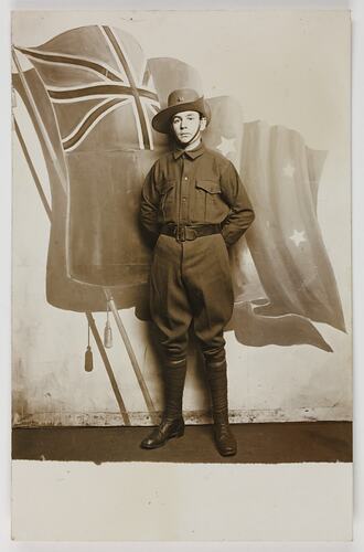 Serviceman standing in front of painting of flag.