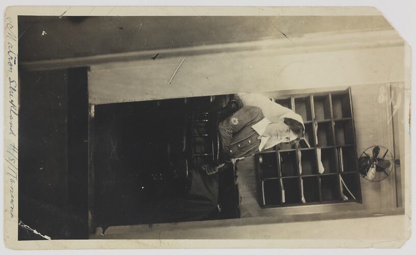 Woman in nurses uniform sitting in chair.