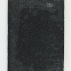 Black covered cardboard notebook.