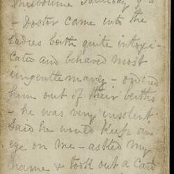 Open diary with handwritten text on discoloured worn page.