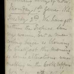 Open diary with handwritten text on discoloured worn page.