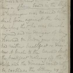 Open diary with handwritten text on discoloured worn page.