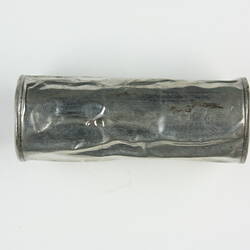Crinkled metal film canister.