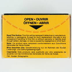 Back of film box with perforated tab to open.