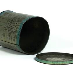 Cylindrical metal tin, on side with lid off