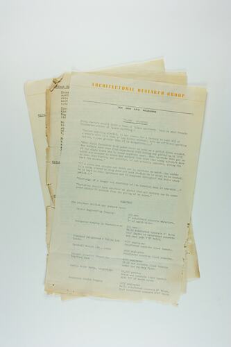 Sheaf of tattered typed documents with yellow font heading