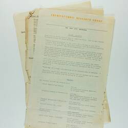 Sheaf of tattered typed documents with yellow font heading