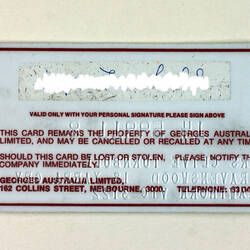 Back of store card, white with red text, signature obscured