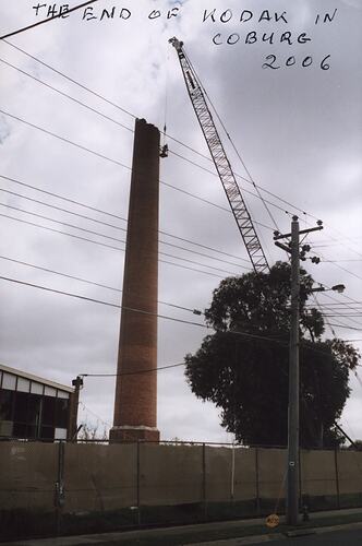 Crane and partially dismantled factory chimney.