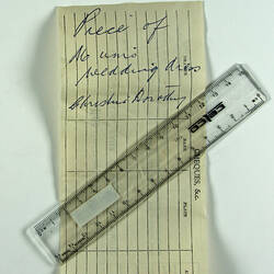 Hand-written note flattened with plastic ruler.