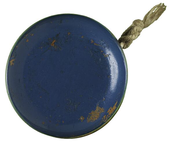 Blue side of blue/green wooden yo-yo with string.