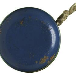 Blue side of blue/green wooden yo-yo with string.