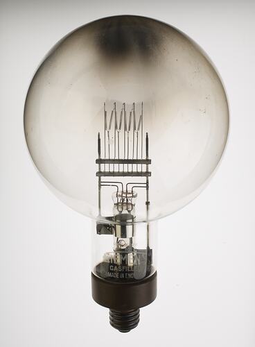 Glass globe with tungsten filament with brass screw cap and single pin contact.