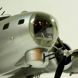 Silver model aeroplane. Detail of nose and propeller.