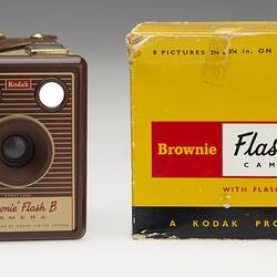 Square brown camera with yellow and black box.