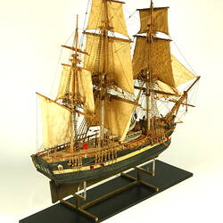 Wooden ship with three masts, three quarter view.