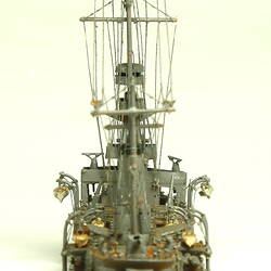 Naval ship with mast, rear view.