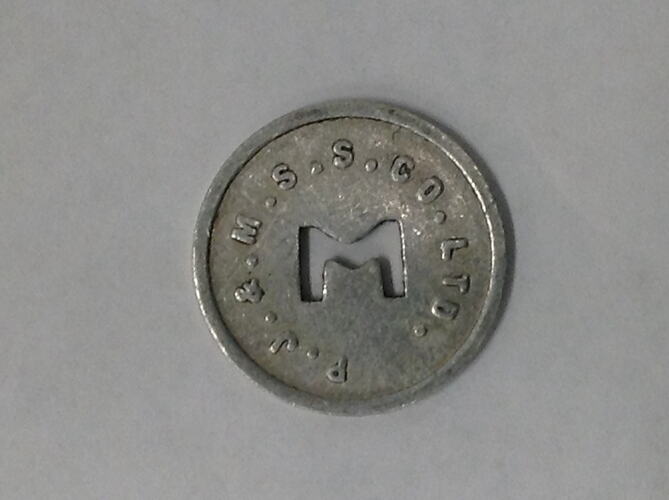 Round coin with M cut out of centre.