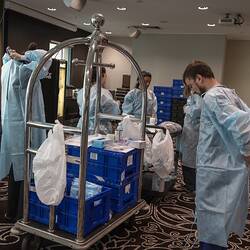 Digital Photograph - Medical Staff getting dressed in PPE, Hotel Quarantine, Novotel on Collins, Melbourne, 14 May 2020