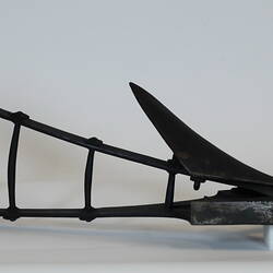 Handheld plough model with large blade, underneath view.