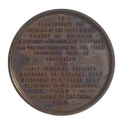 Round medal with text in relief.