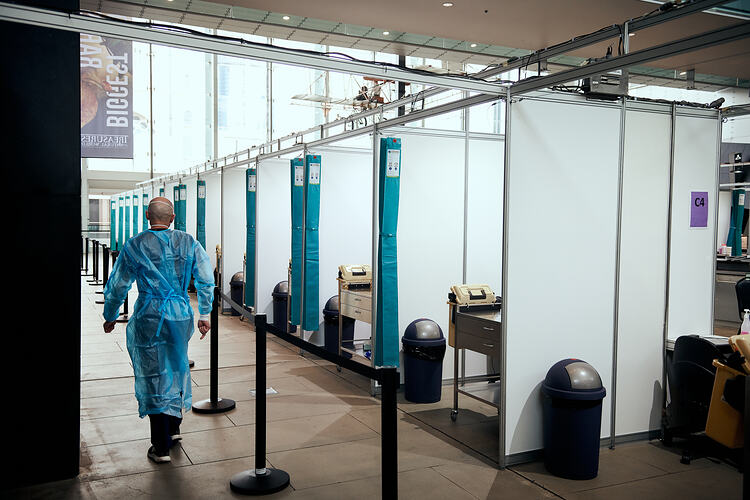 Staff Member walks through Foyer, St Vincent's Vaccination Hub, Melbourne Museum, 23 Sep 2021