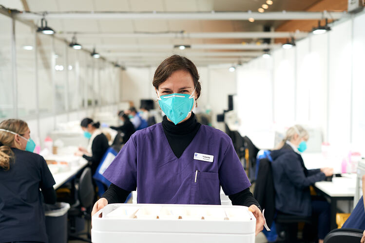 Pharmacist with trays of Prepared Syringes, St Vincent's Vaccination Hub, Melbourne Museum, 23 Sep 2021
