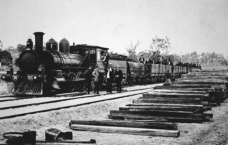 Locomotive with rail trucks carrying groups of men, Bruthen district, circa 1915.