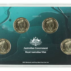 Four silver coins with woman's portrait set in blue/green card. White printed text.