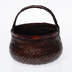 Wicker charcoal pot with top handle.