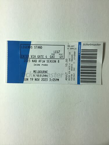 White and blue ticket with black printed text and barcode.