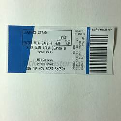 White and blue ticket with black printed text and barcode.