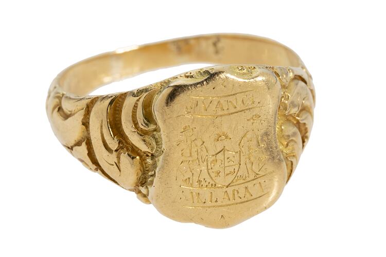 Large gold ring with central shield design featuring the words "Advance Ballaarat" and two miners leaning on a coat of arms.
