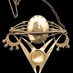 Back of delicate gold inverted triangle brooch with two main pearls framed by seed pearls and blue paste. Fine gold chain and pin extend from top right corner.