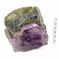 Blocky crystal with purple surface and green surfaces.