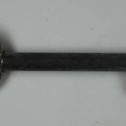 Metal key facing right.