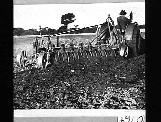 Man on a tractor ploughing a field.