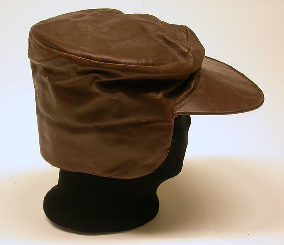 Brown Leather Cap with brim and neck flap.