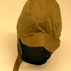 Khaki hat with ear covers and chin strap.