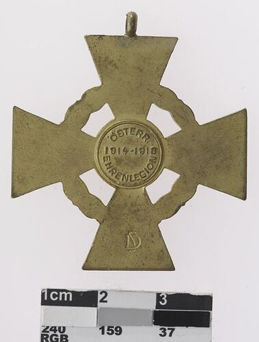 Cross shaped medal with text in centre.