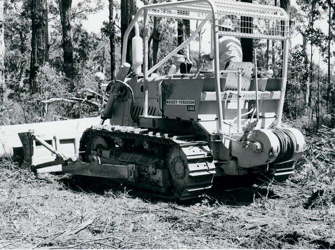 Rear view of crawler tractor in forest.