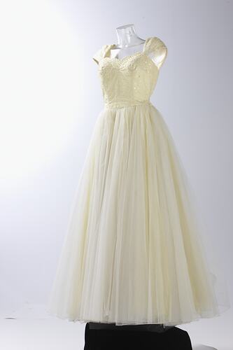 Full length cream evening gown, yellow sequins.