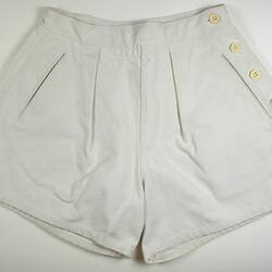 White shorts with four bottons down right side.