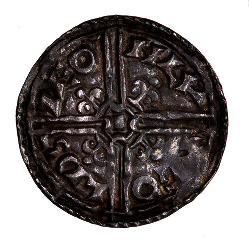 Coin, round, Long cross, voided with fleur-de-lis in the angles; text around, '+ GOLDSIE ON LV'.
