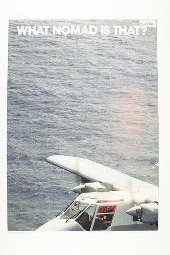 Front section of grey plane flying low over sea. White text at top of page.