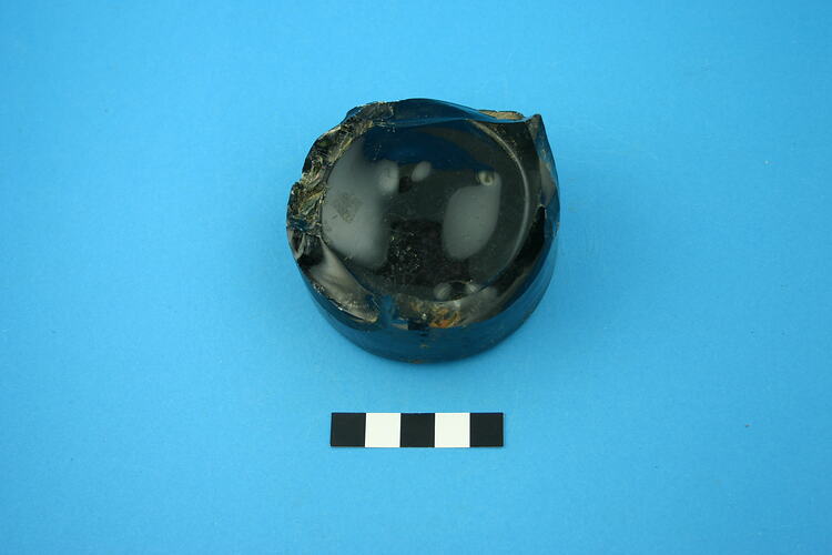 One glass bottle base, dark green.